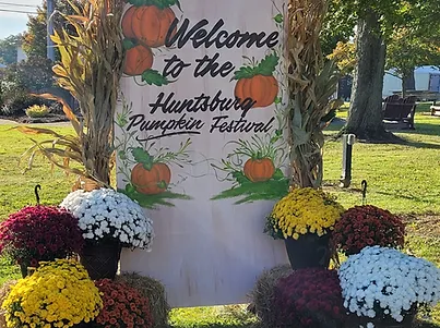 A sign that says "welcome to the Huntsburg Pumpkin Festival"
